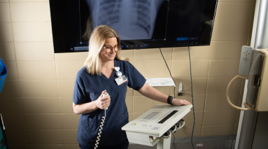 Technician getting read to start xray in training lab.